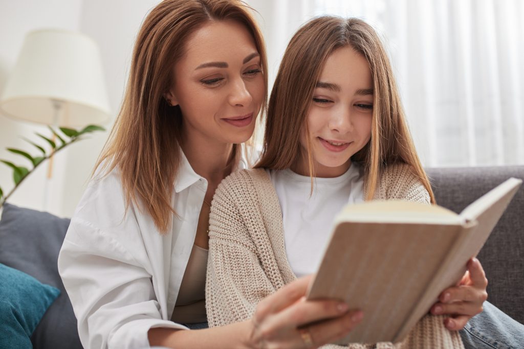 Mother and young daughter reading together